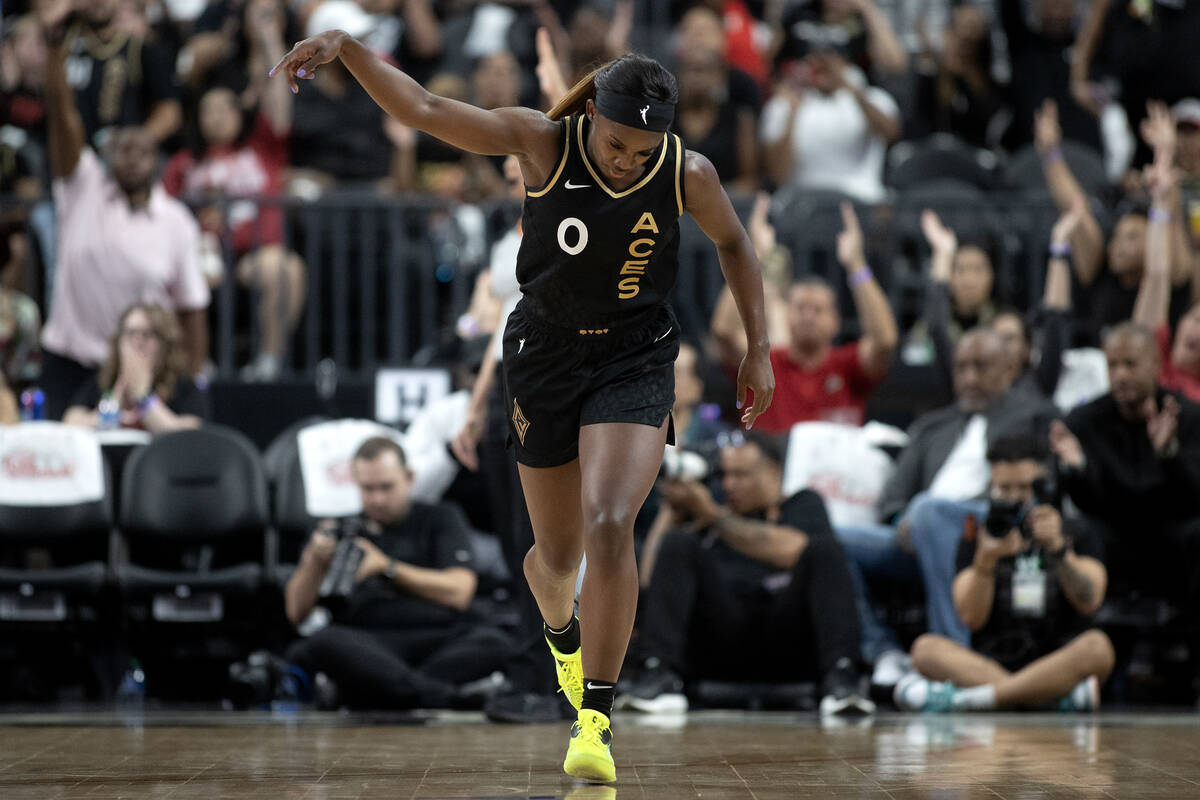 Las Vegas Aces guard Jackie Young (0) dunks in the air after scoring a three-pointer during the ...