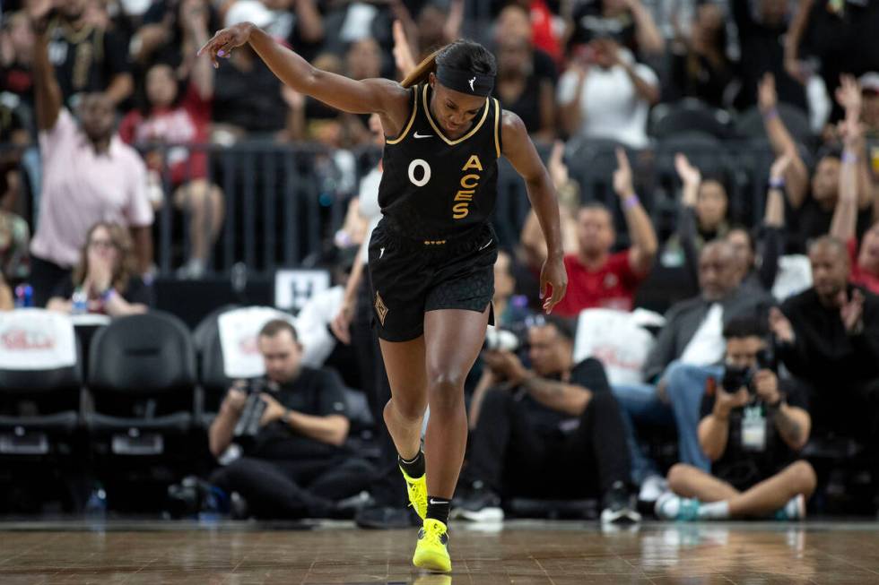 Las Vegas Aces guard Jackie Young (0) dunks in the air after scoring a three-pointer during the ...