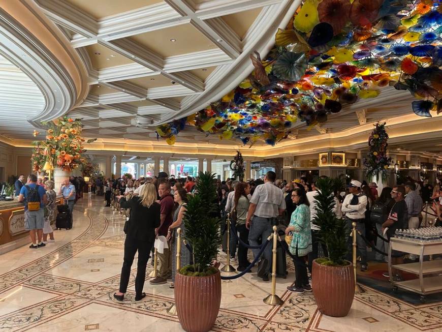 A crowd of people wait to check in with the front desk at the Bellagio on Wednesday Sept. 13, 2 ...