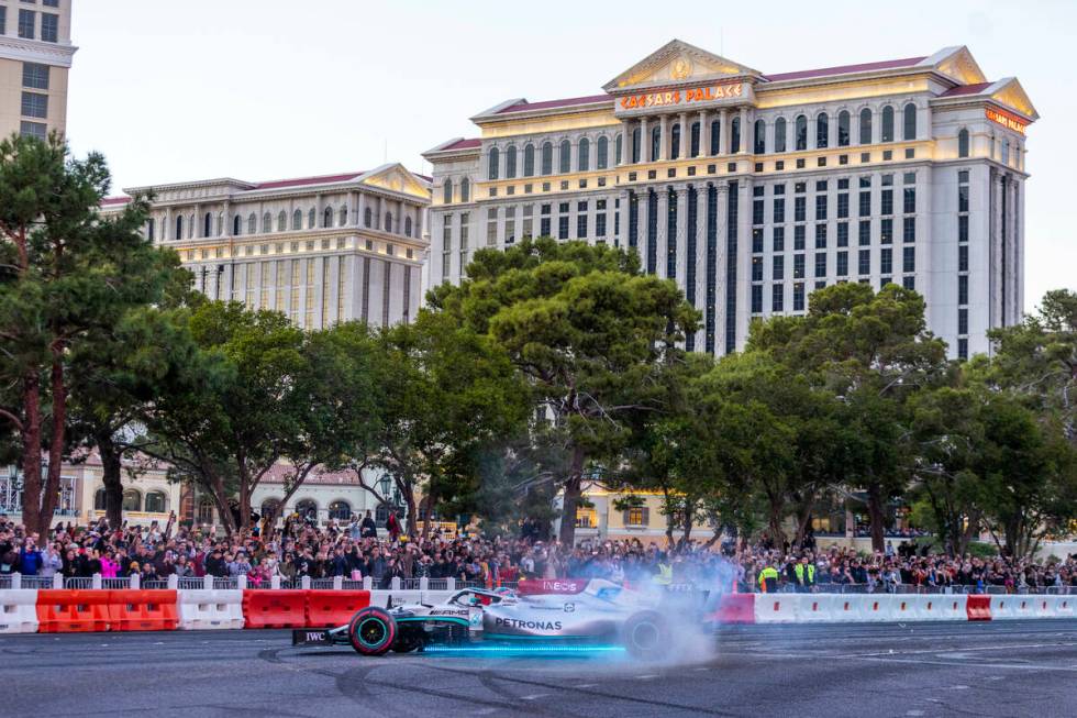 Racer George Russell turns doughnuts across from the Bellagio while racing down the Strip durin ...