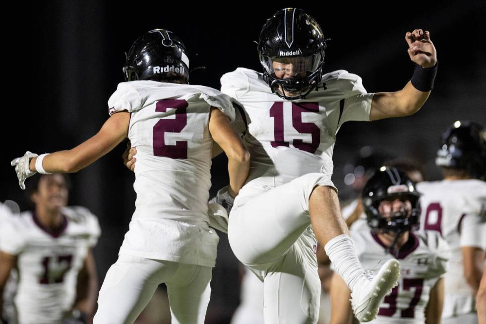 Faith Lutheran wide receiver Brandon Soares (2) and Faith Lutheran quarterback Alex Rogers (15) ...