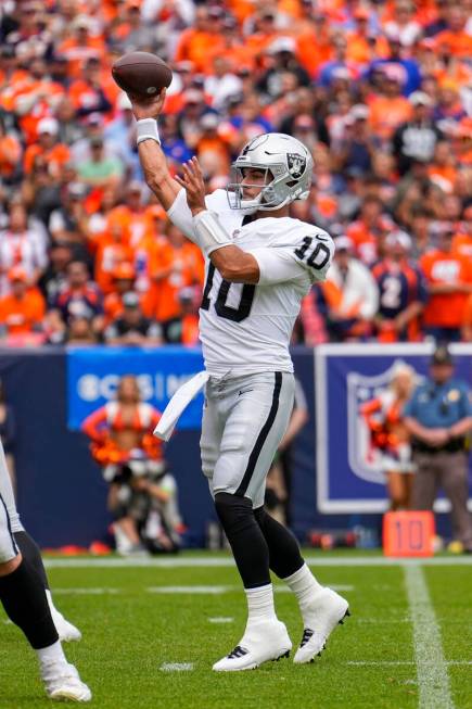 Las Vegas Raiders quarterback Jimmy Garoppolo throws a touchdown pass against the Denver Bronco ...