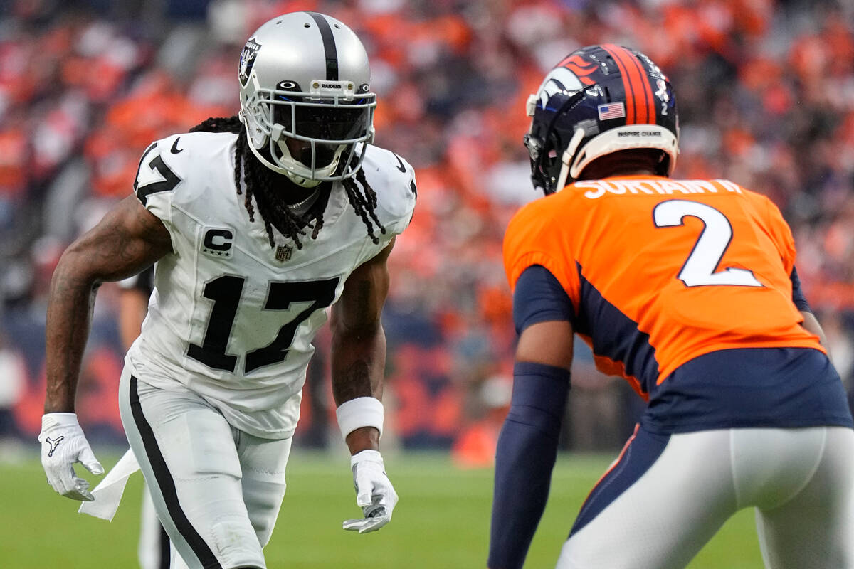 Las Vegas Raiders wide receiver Davante Adams (17) lines up against Denver Broncos cornerback P ...