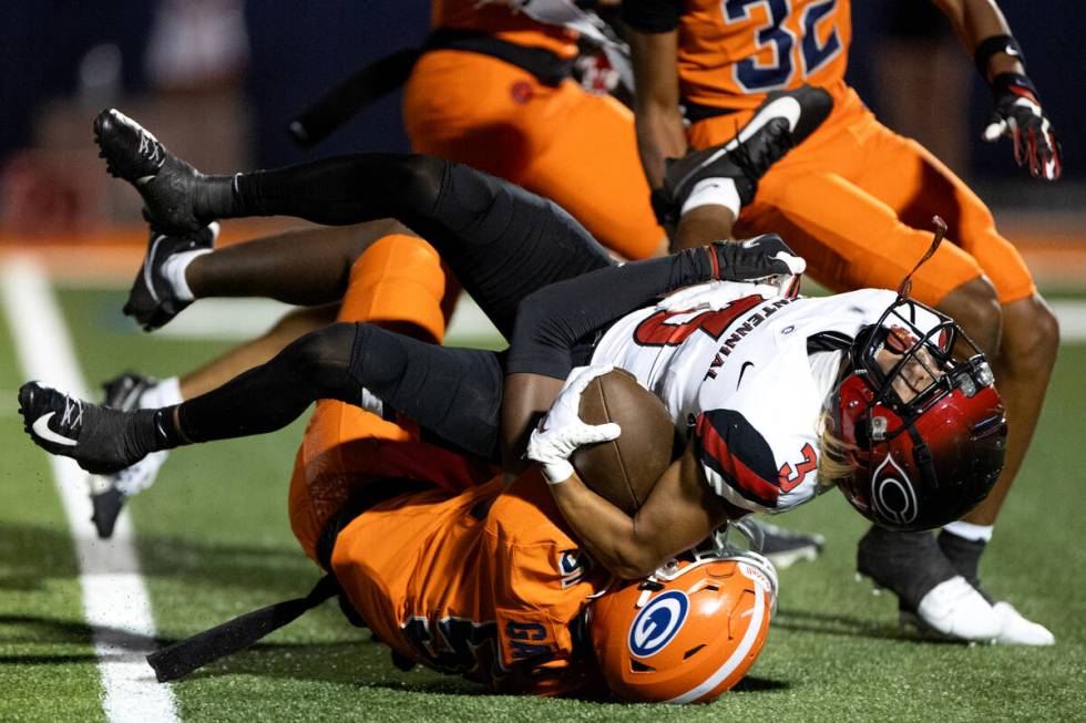 Bishop Gorman defensive back Jett Washington (5) tackles Centennial wide receiver Seth Zamora ( ...