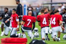 (From left) Raiders quarterback Jimmy Garoppolo (10) and Brian Hoyer (7) talk while stretching ...