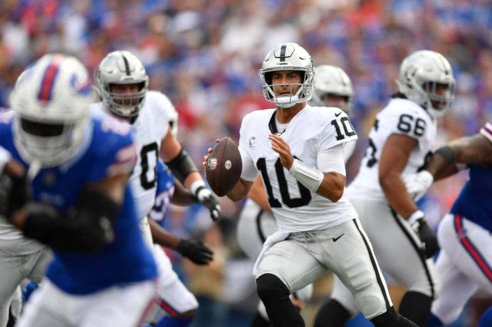 Las Vegas Raiders quarterback Jimmy Garoppolo (10) looks to pass during the first half of an NF ...