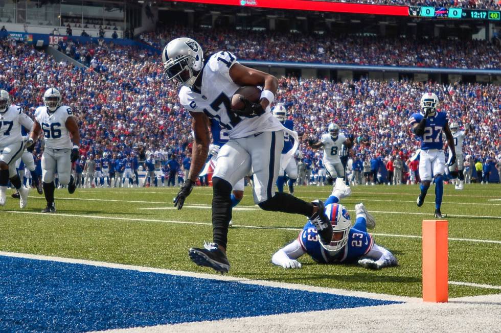 Las Vegas Raiders wide receiver Davante Adams (17) runs past Buffalo Bills safety Micah Hyde (2 ...