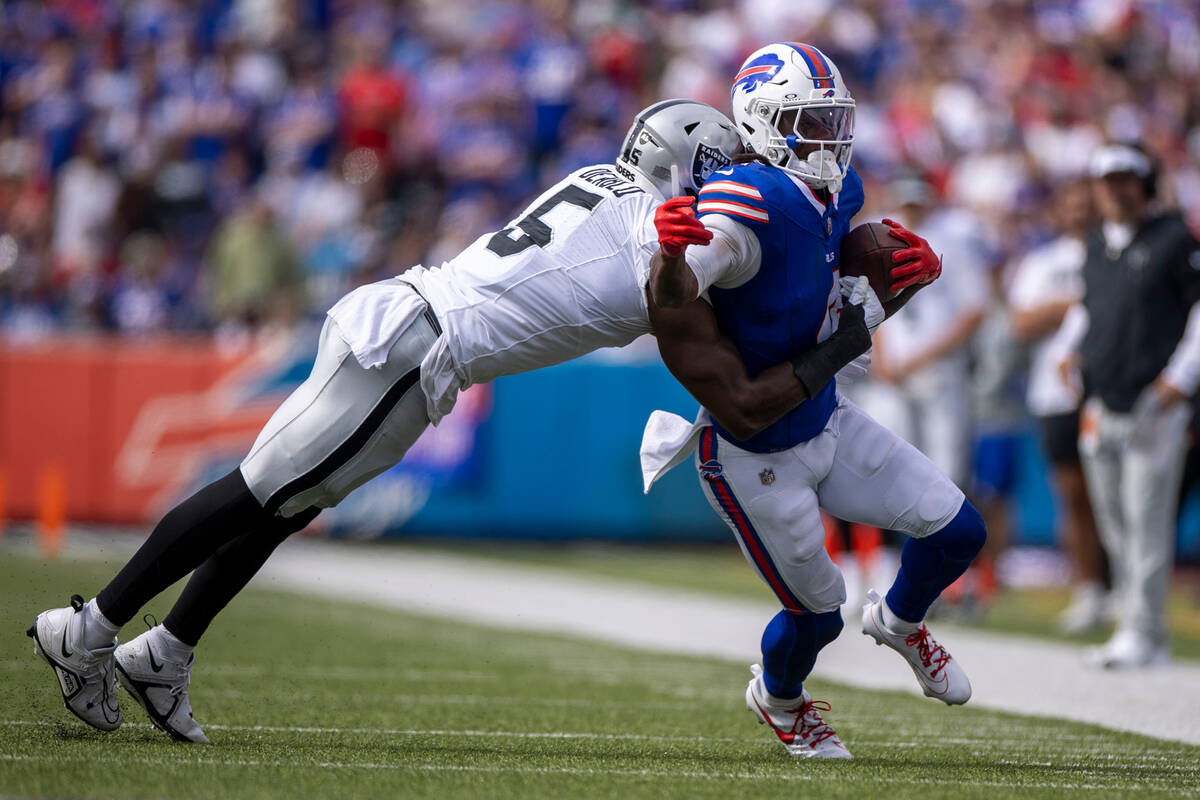 Raiders linebacker Divine Deablo (5) makes a tackle on Buffalo Bills running back James Cook (4 ...