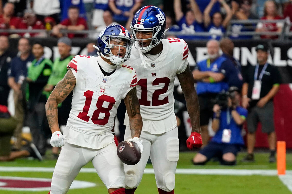 New York Giants tight end Darren Waller (12) celebrates with wide receiver Isaiah Hodgins (18) ...