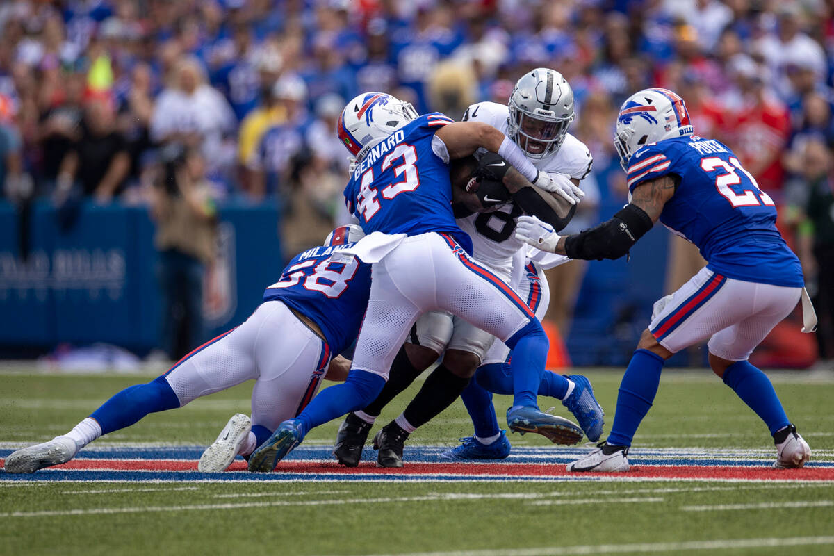 Raiders running back Josh Jacobs (8) is gang tackled by Buffalo Bills linebacker Matt Milano (5 ...