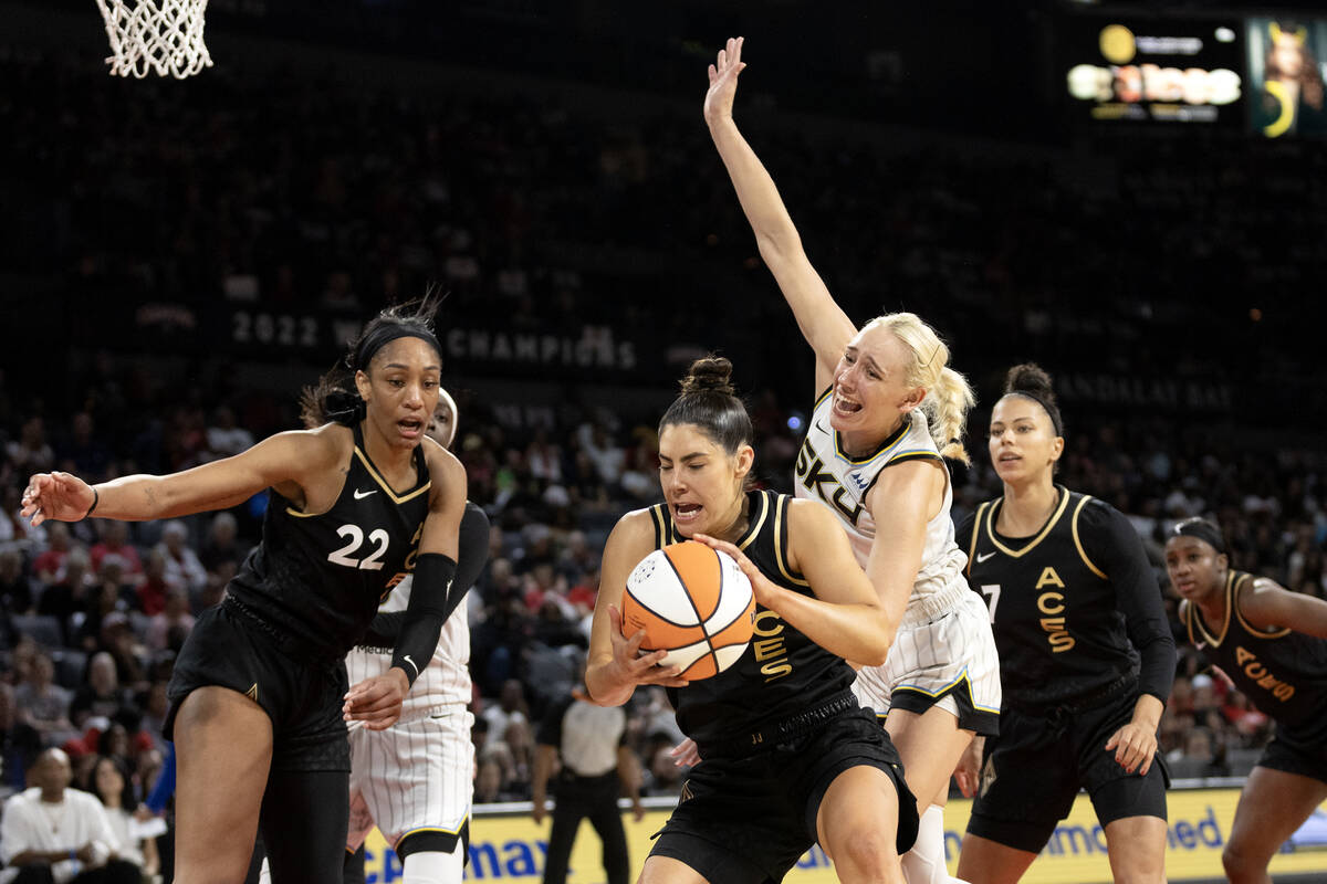 Las Vegas Aces guard Kelsey Plum, center left, snags a rebound off of a Chicago Sky missed free ...