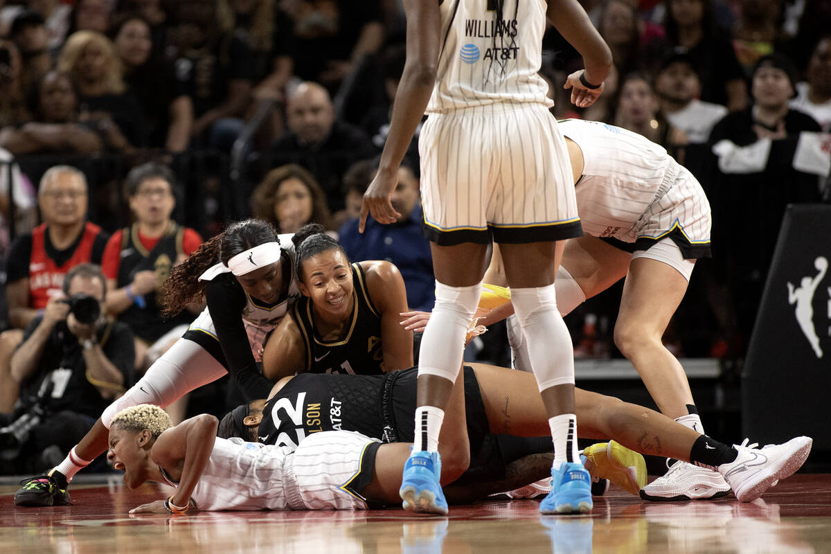 The Las Vegas Aces and the Chicago Sky struggle for the ball during the first half of Game 2 in ...