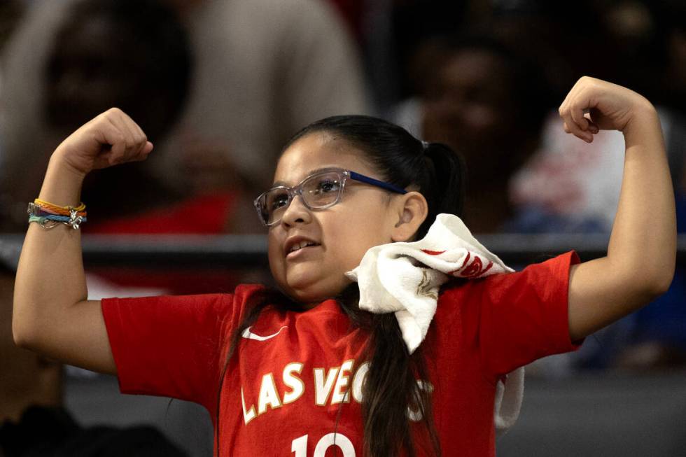 A young Las Vegas Aces fan flexes her muscles during the second half of Game 2 in a first-round ...