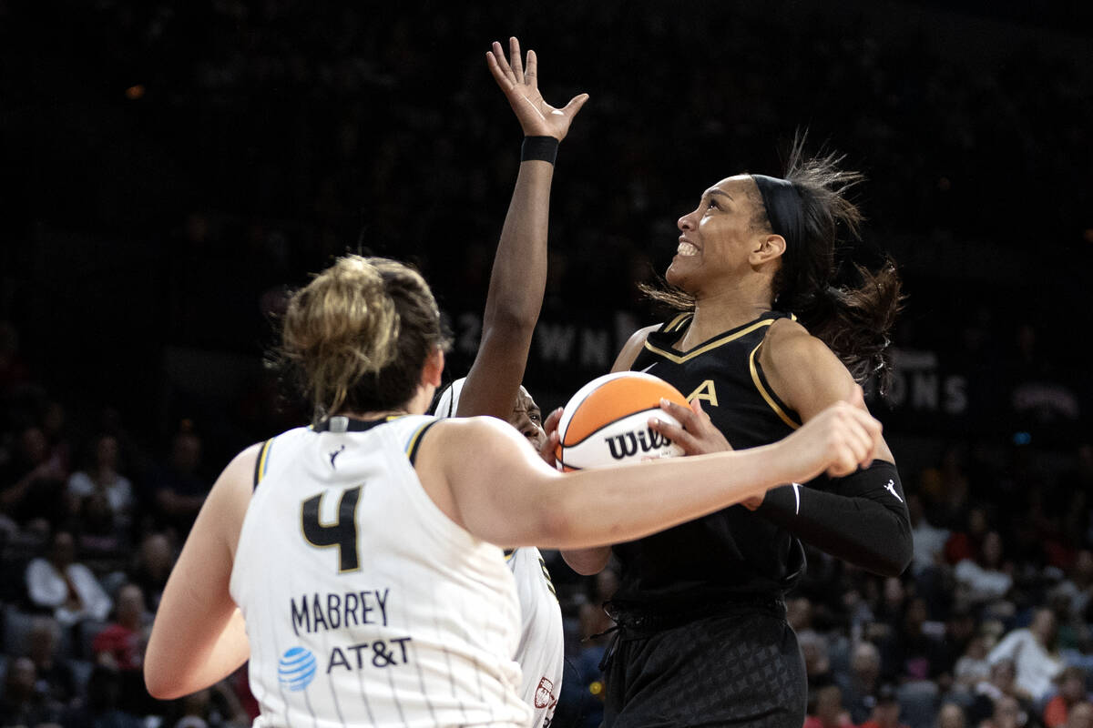 Las Vegas Aces forward A'ja Wilson (22) shoots against Chicago Sky forward Robyn Parks, center, ...