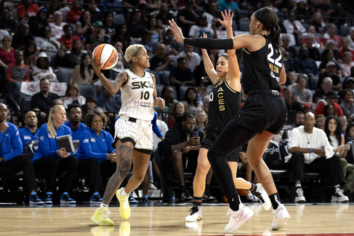 Chicago Sky guard Courtney Williams (10) is surrounded by Las Vegas Aces guard Kelsey Plum (10) ...