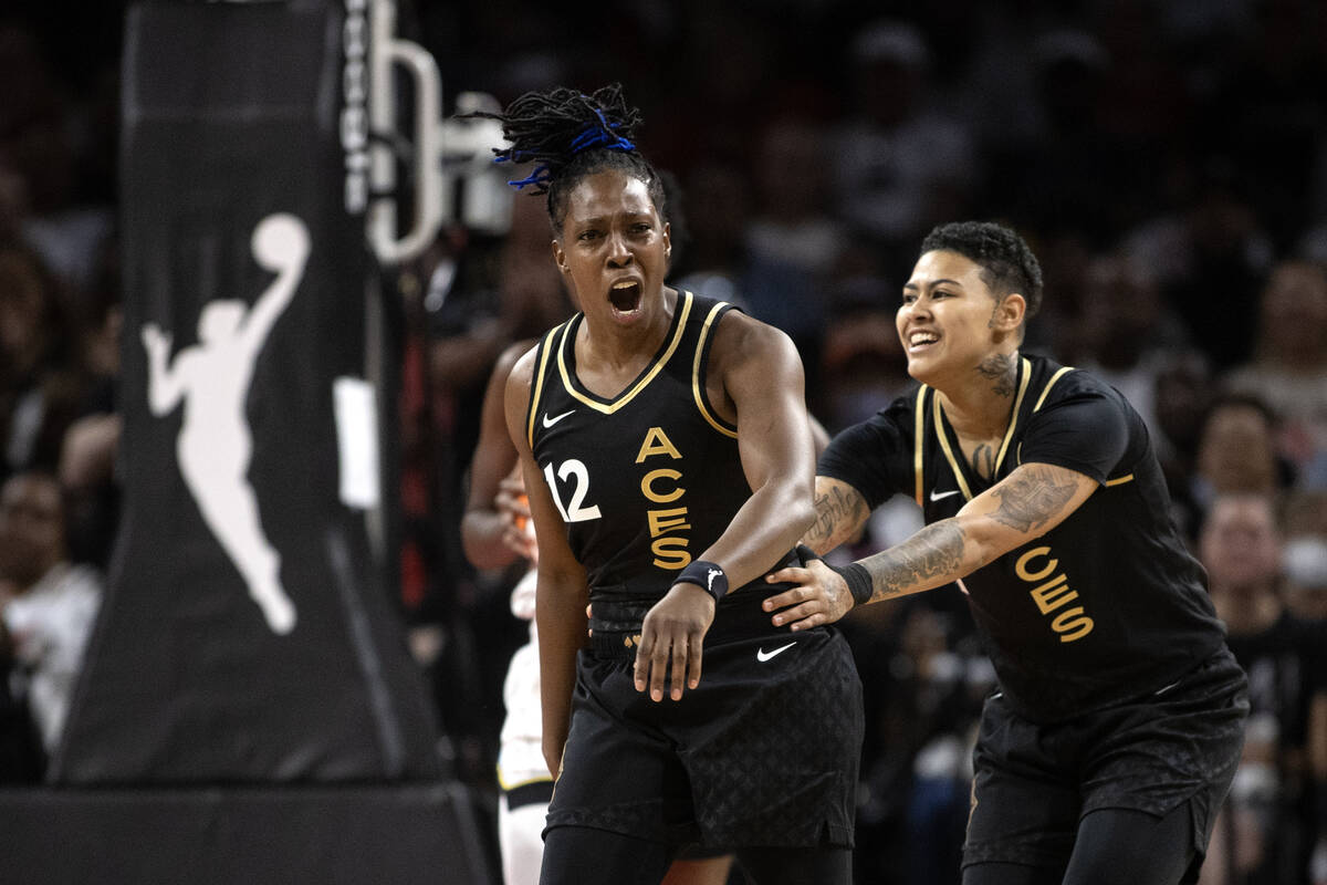 Las Vegas Aces guard Kierstan Bell, right, ushers guard Chelsea Gray (12) away from the court a ...