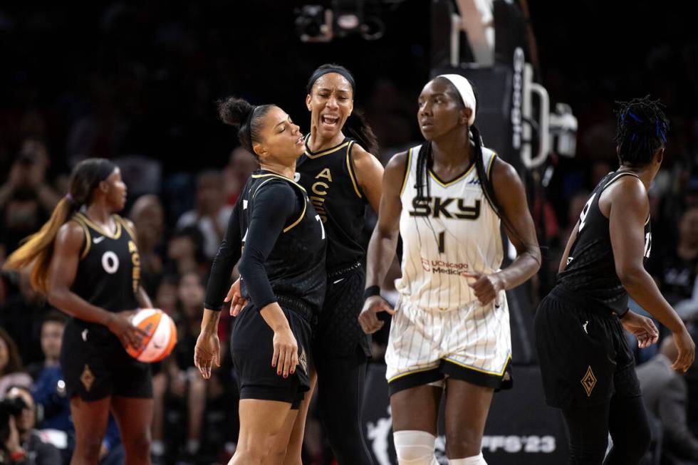 Las Vegas Aces forward Alysha Clark (7) bumps chests with forward A'ja Wilson (22) after their ...