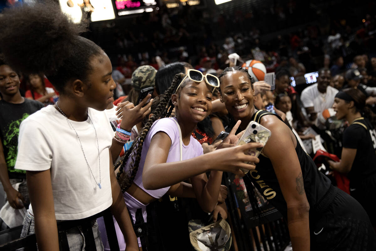 Las Vegas Aces center Alaina Coates (81) poses for photos with fans after winning Game 2 in a f ...