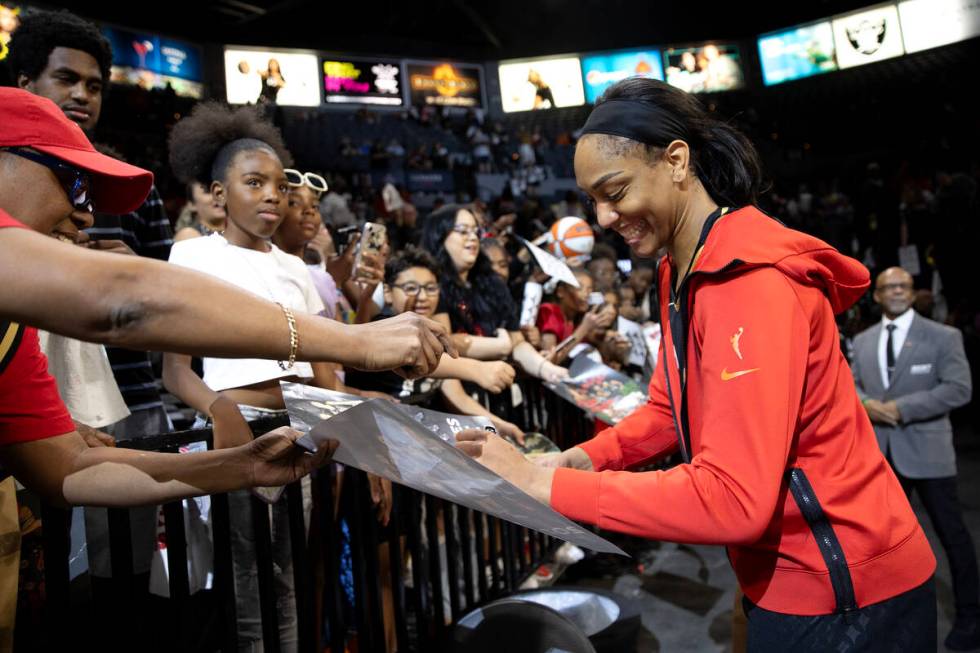 Las Vegas Aces forward A'ja Wilson signs autographs for fans after winning Game 2 in a first-ro ...