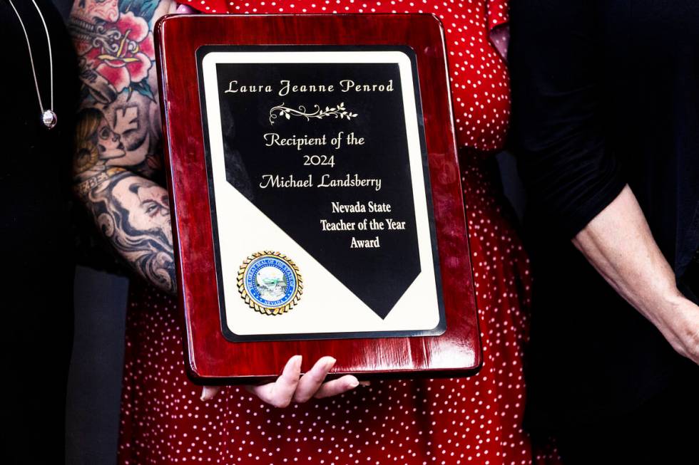 Laura Penrod, an english teacher at Southwest Career and Technical Academy, holds her award for ...