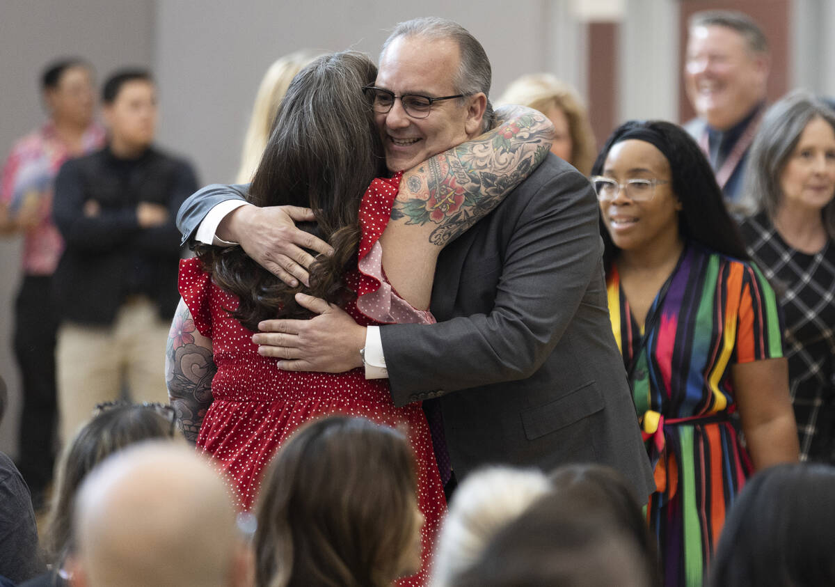 Laura Penrod, left, an english teacher at Southwest Career and Technical Academy, hugs Clark Co ...