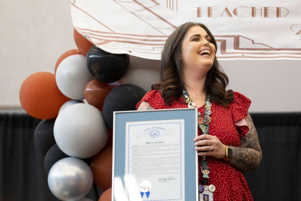 Laura Penrod, an english teacher at Southwest Career and Technical Academy, reacts after winnin ...