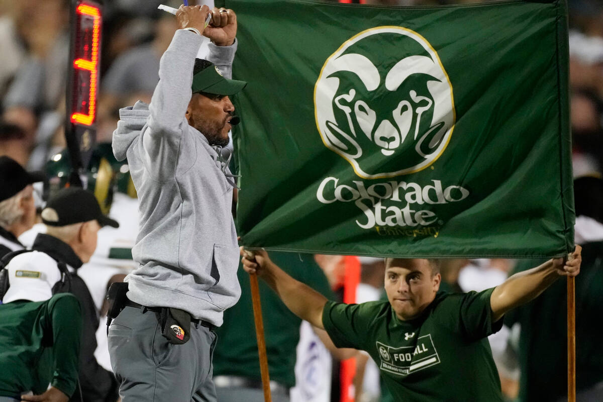 Colorado State head coach Jay Norvell, front left, jumps while calling plays in the first half ...