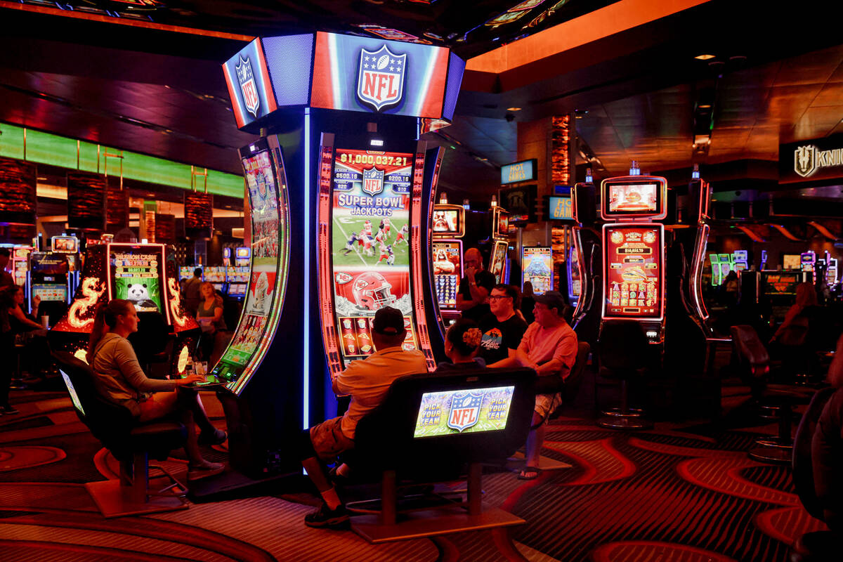 Guests play the first Vegas NFL slot machine at the M Resort in Las Vegas, Monday, Sept. 18, 20 ...