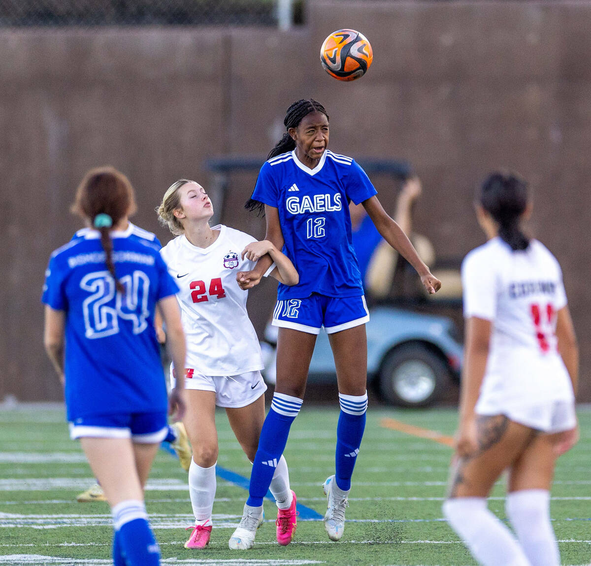 Bishop Gorman midfielder Amiya Warner (12) heads the ball away from Coronado forward Aubrey Wag ...