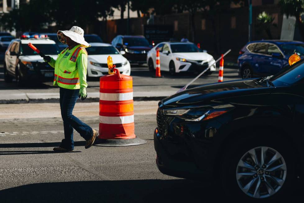 A person directs traffic while the street is under construction for the Formula One Las Vegas G ...