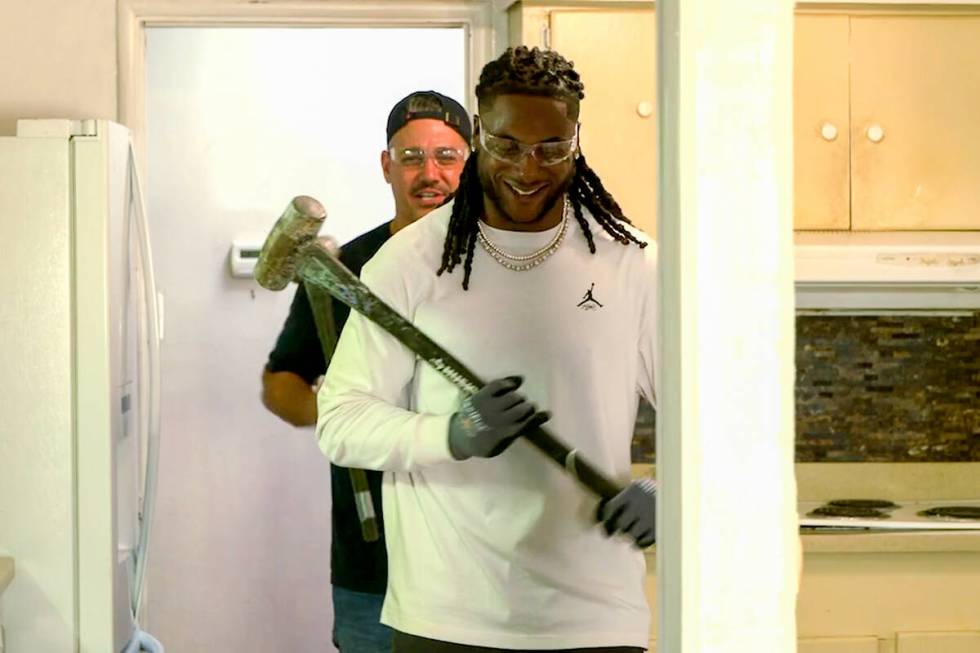 Raiders All-Pro wide receiver Davante Adams trades his football for a sledgehammer as he gifts ...