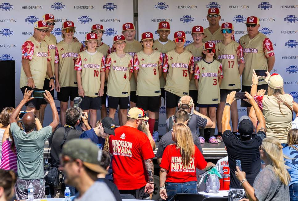 Henderson Little League team players and coaches gather on stage for a group shot during a cele ...