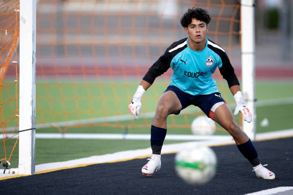 Coronado goalkeeper Logan Pierce eyes the ball before making a save during the first half of a ...