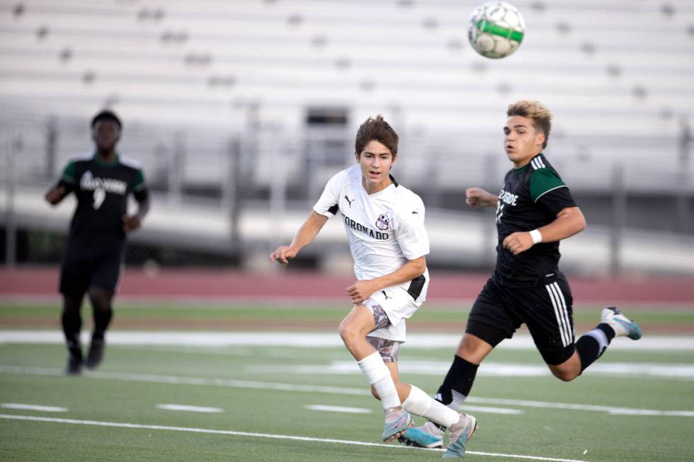 Coronado’s Grayson Elisaldez, left, watches his pass while Palo Verde forward Carson Den ...