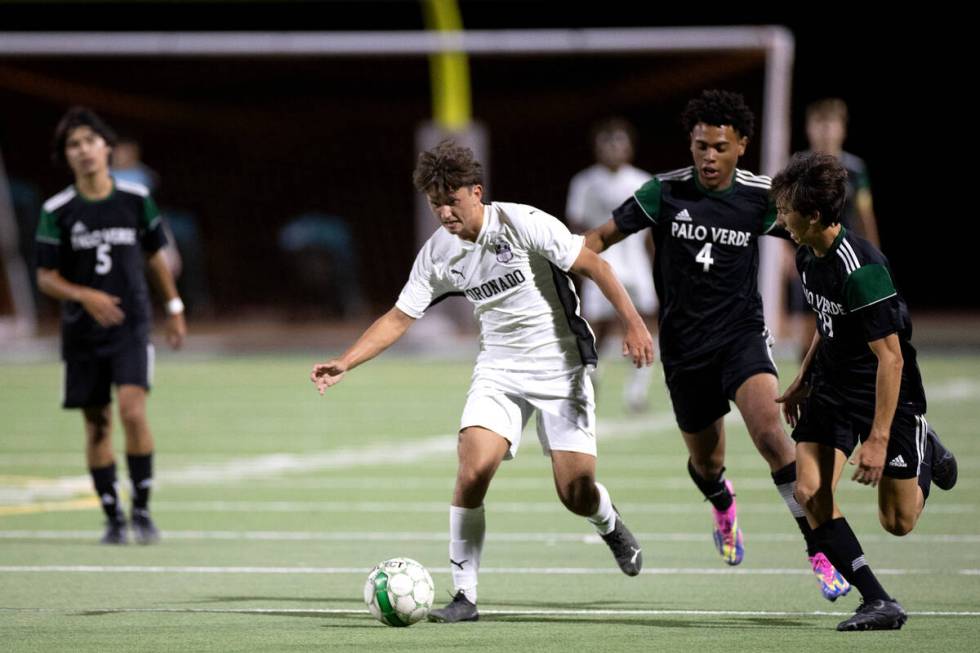 Coronado defender Silvestre Cahue, center, breaks away toward the goal while Palo Verde’s Aja ...