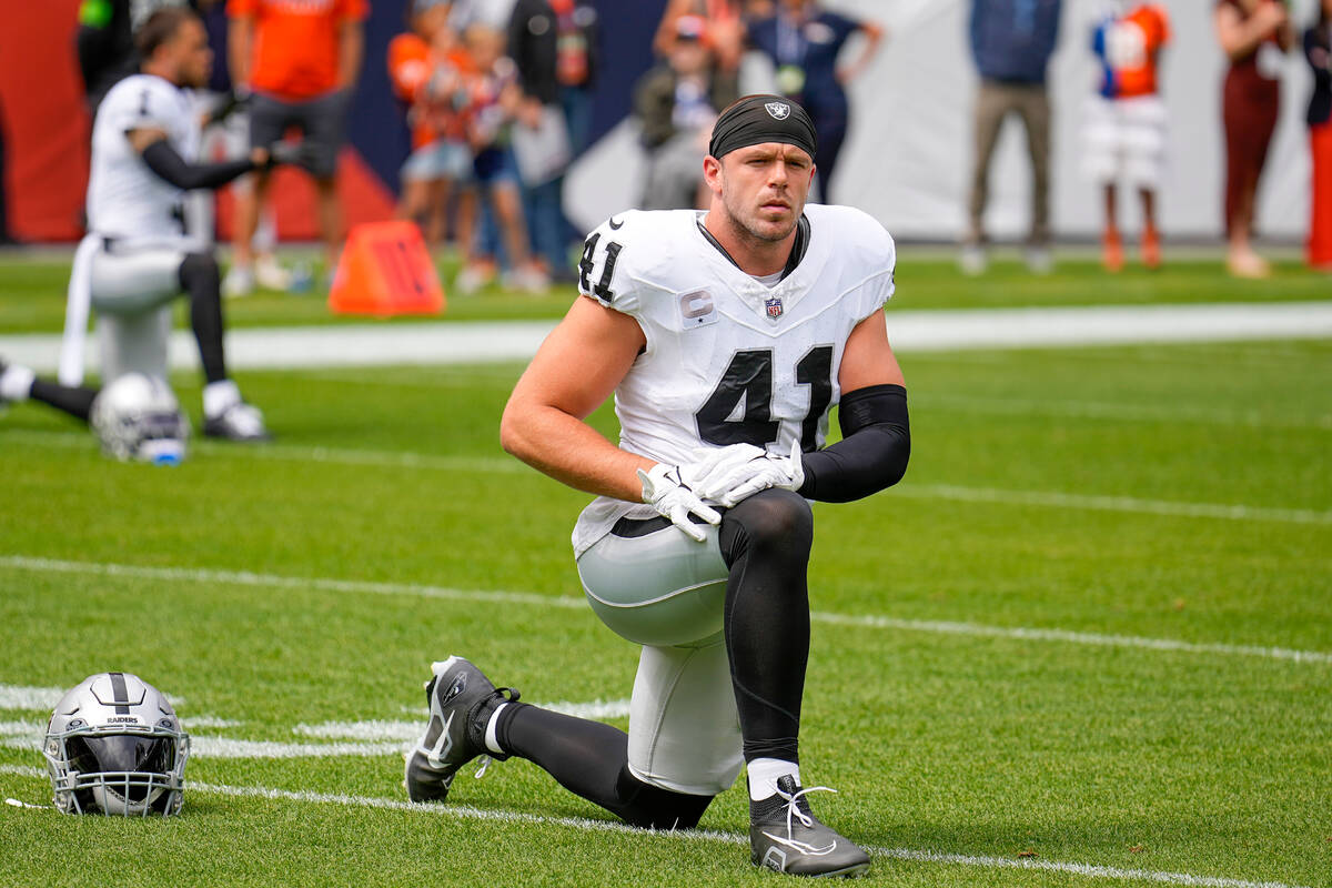 Las Vegas Raiders linebacker Robert Spillane stretches before an NFL football game against the ...