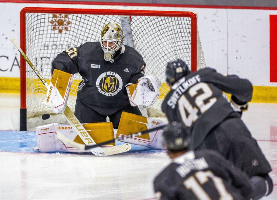 Golden Knights goalie Jiri Patera (30) deflects a shot attempt by forward Alex Swetlikoff (42) ...