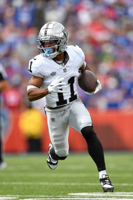 Las Vegas Raiders wide receiver Tre Tucker (11) runs with the ball during the first half of an ...