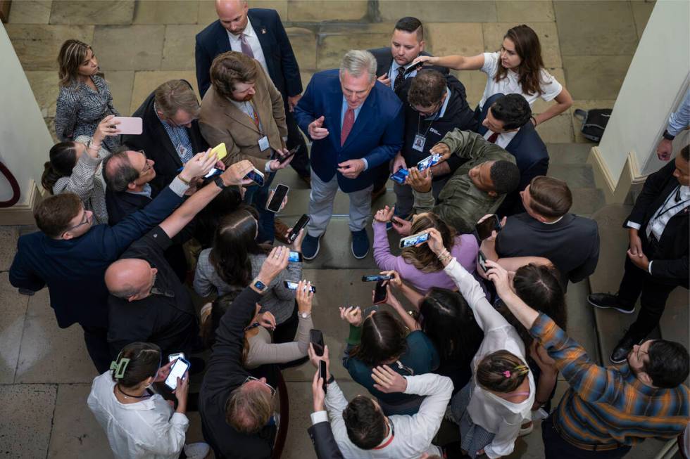 Speaker of the House Kevin McCarthy, R-Calif., is surrounded by reporters looking for updates o ...