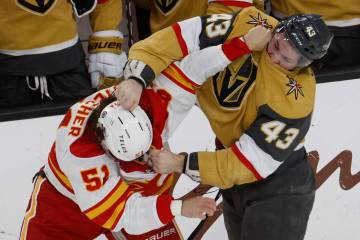 Calgary Flames defenseman Troy Stecher (51) fights with Vegas Golden Knights center Paul Cotter ...