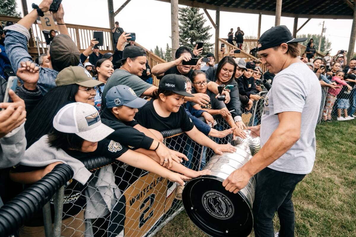 Golden Knights defenseman Zach Whitecloud shows off the Stanley Cup during a visit to the Sioux ...