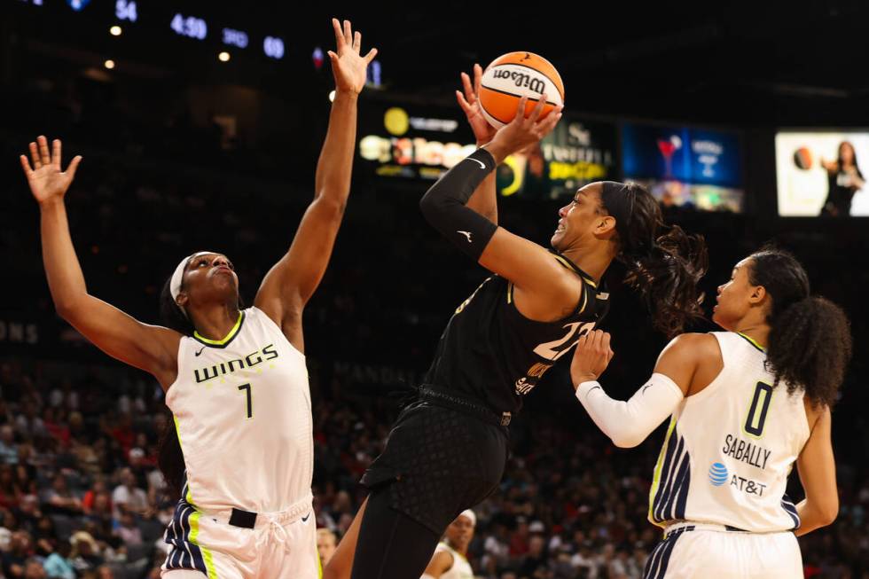 Las Vegas Aces forward A'ja Wilson (22) shoots a layup as Dallas Wings center Teaira McCowan (7 ...