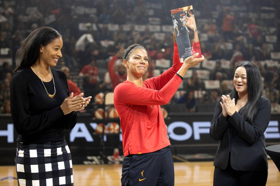 Las Vegas Aces forward Alysha Clark holds up her trophy for winning the WNBA Sixth Woman of the ...
