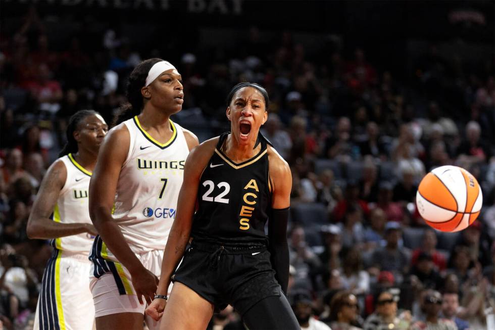 Las Vegas Aces forward A'ja Wilson (22) celebrates after Dallas Wings center Teaira McCowan (7) ...