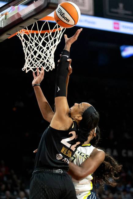 Las Vegas Aces forward A'ja Wilson (22) is fouled by Dallas Wings center Teaira McCowan, behind ...