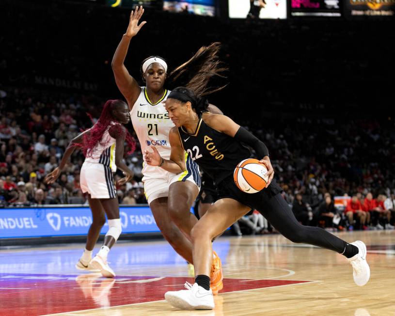 Las Vegas Aces forward A'ja Wilson (22) drives toward the hoop past Dallas Wings center Kalani ...