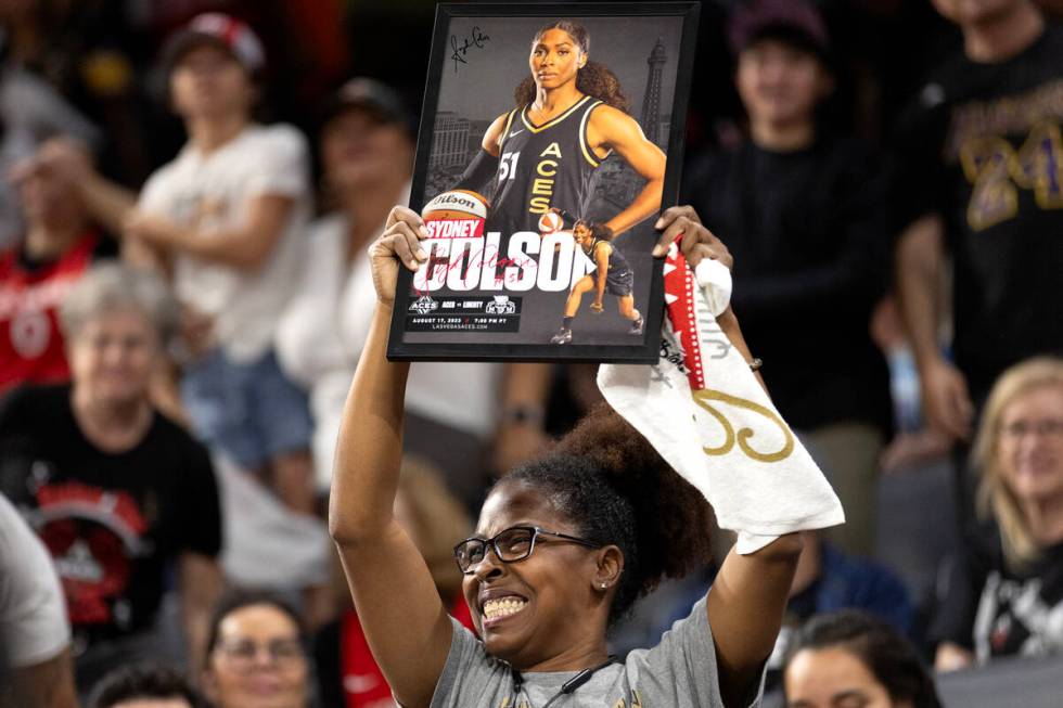 An Las Vegas Aces fan holds up a Sydney Colson poster during the second half in Game 1 of a WNB ...