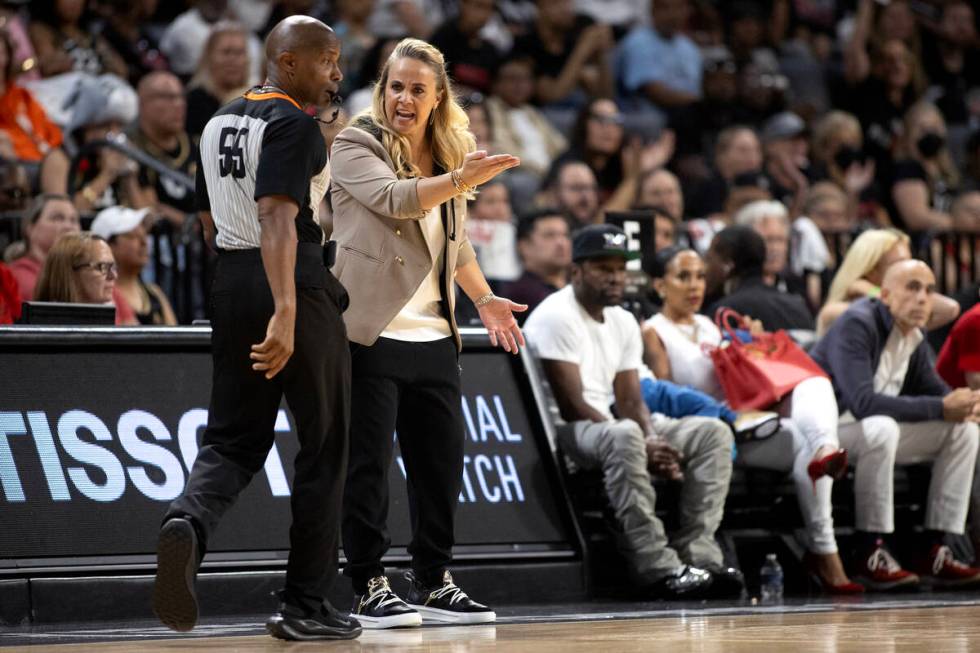 Las Vegas Aces head coach Becky Hammon disputes a foul called by referee Eric Brewton (55) duri ...