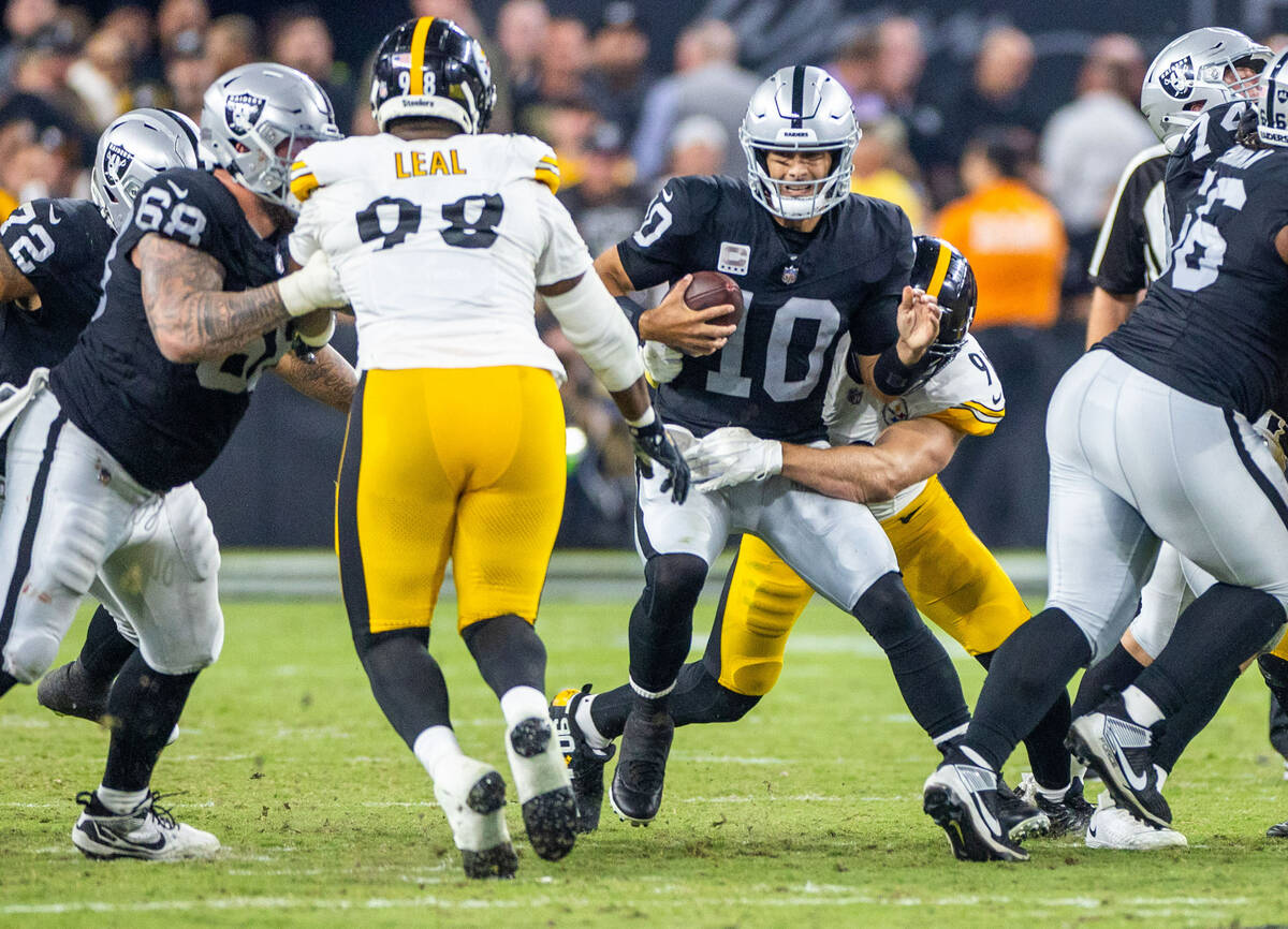 Raiders quarterback Jimmy Garoppolo (10) is sacked and injured while sacked by Pittsburgh Steel ...