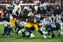 Pittsburgh Steelers running back Najee Harris (22) tries to muscle his way through Raiders def ...